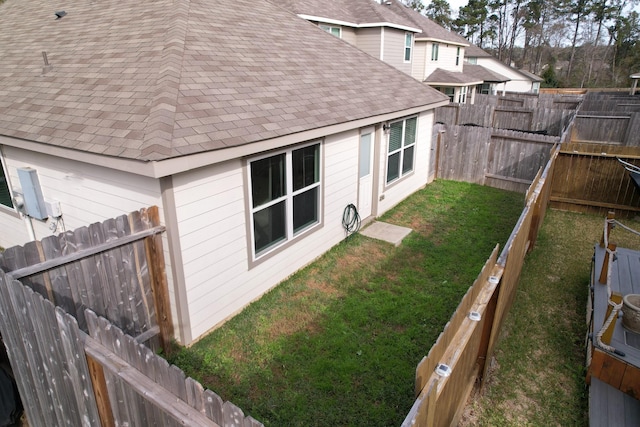 view of side of property with a yard