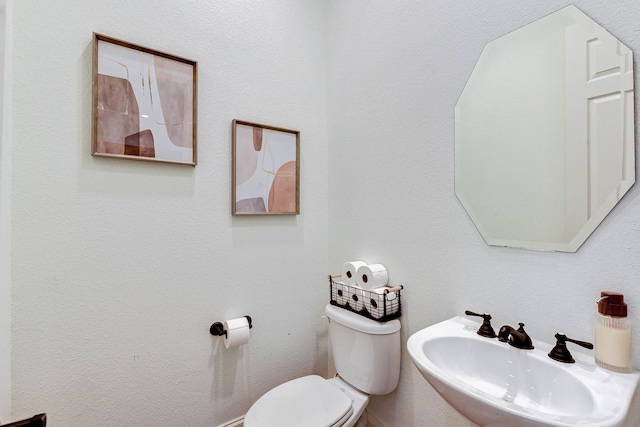 bathroom with toilet and sink