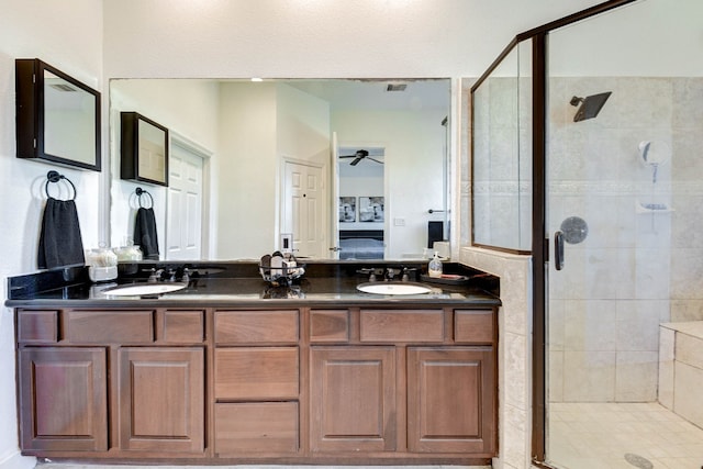 bathroom featuring vanity, ceiling fan, and an enclosed shower