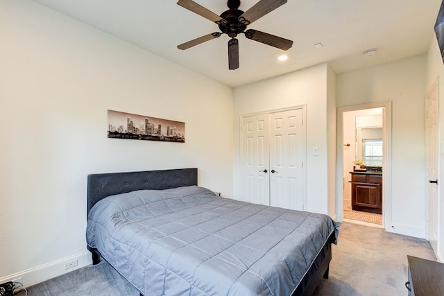 carpeted bedroom with ceiling fan and a closet