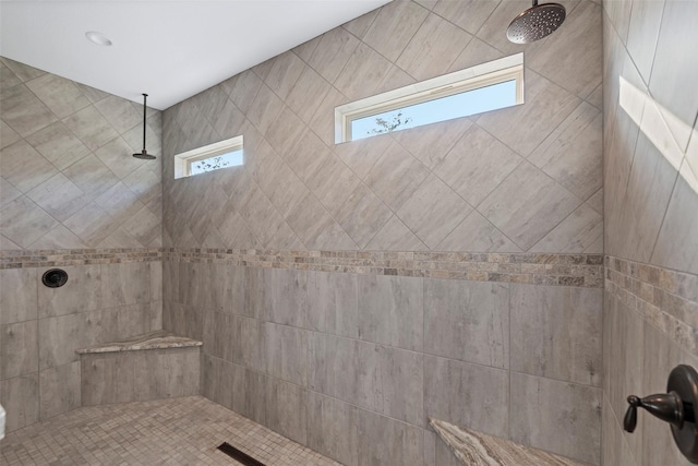 bathroom featuring a tile shower and visible vents