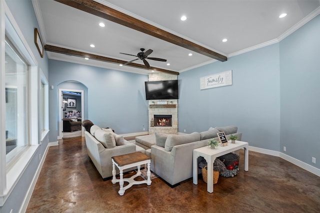 living area with a stone fireplace, recessed lighting, baseboards, beamed ceiling, and finished concrete floors