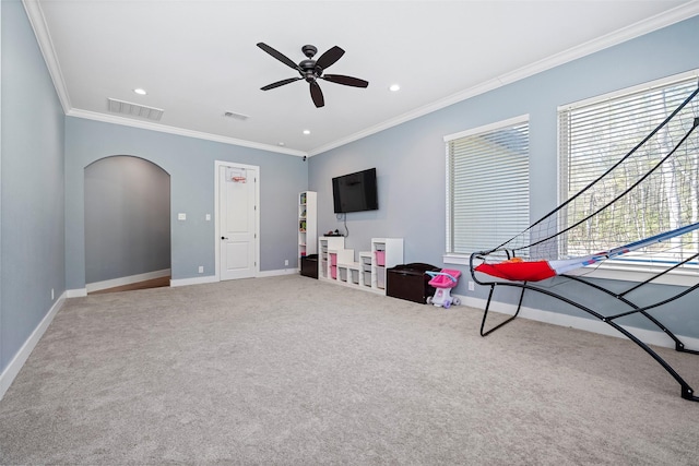 playroom featuring arched walkways, ornamental molding, and visible vents