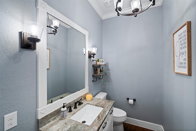 half bath featuring toilet, visible vents, baseboards, vanity, and crown molding