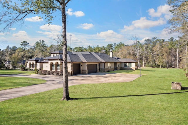 view of front of house featuring an attached garage, solar panels, driveway, stone siding, and a front yard