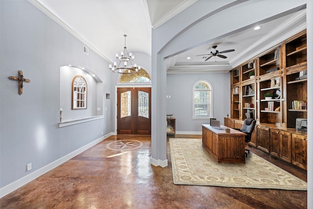 entrance foyer with ceiling fan with notable chandelier, baseboards, concrete flooring, and ornamental molding