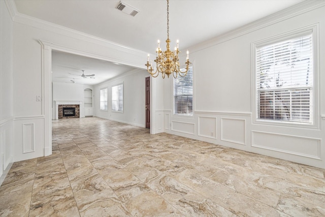 4505 Mimosa Dr, Bellaire, TX 77401 - unfurnished dining area with crown molding, built in shelves, a wealth of natural light, and ceiling fan with notable chandelier