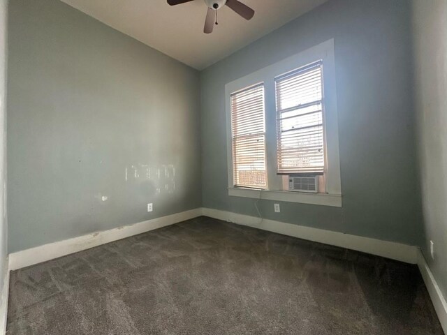 unfurnished room featuring cooling unit, vaulted ceiling, ceiling fan, and dark colored carpet