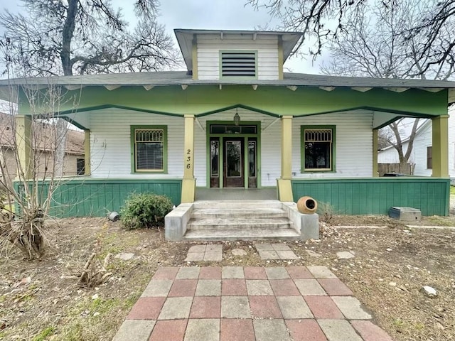 doorway to property featuring covered porch