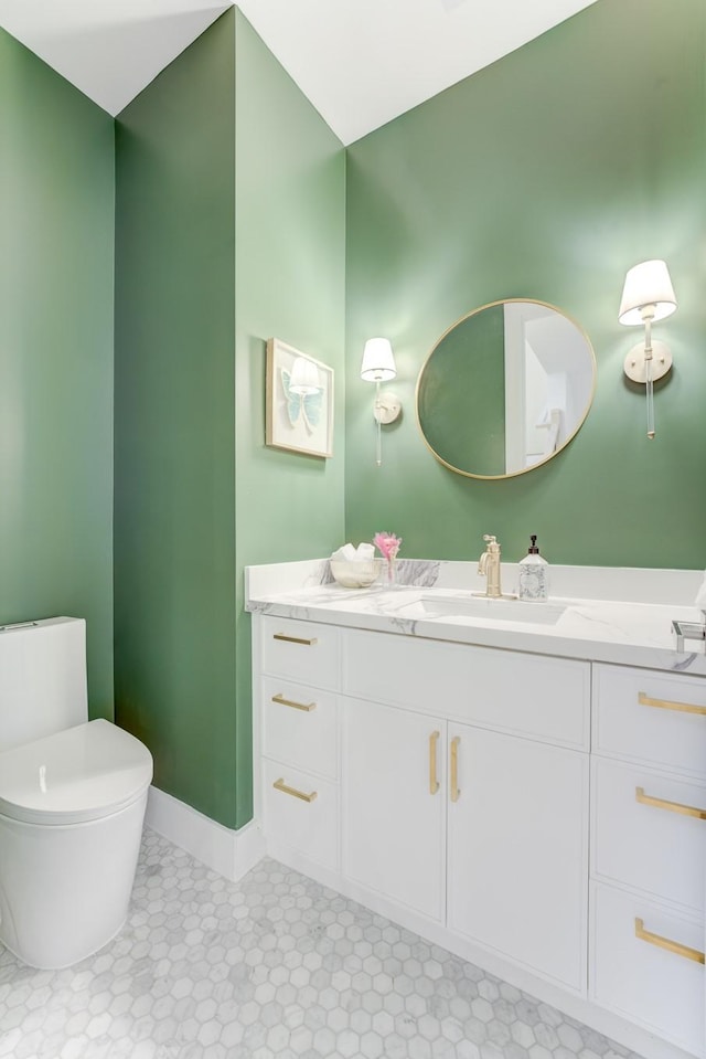 bathroom featuring vanity and toilet