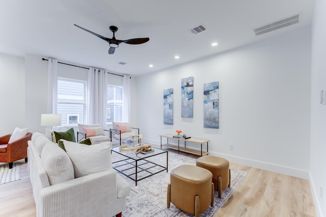 living room featuring ceiling fan and light wood-type flooring