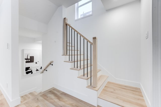 stairway featuring wood-type flooring