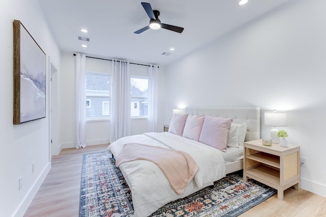 bedroom with light hardwood / wood-style floors and ceiling fan