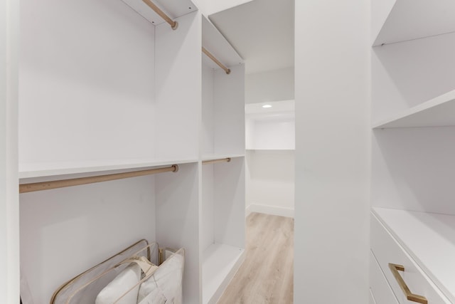 walk in closet featuring light hardwood / wood-style flooring