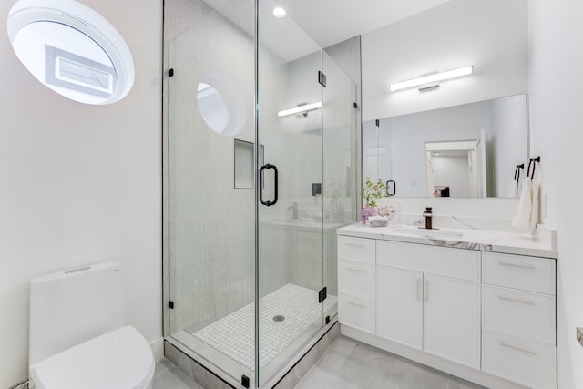 bathroom featuring vanity, toilet, and walk in shower