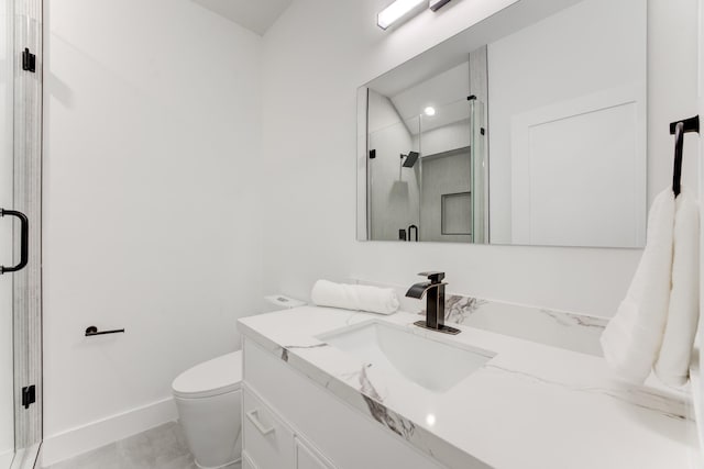 bathroom with vanity, toilet, and an enclosed shower