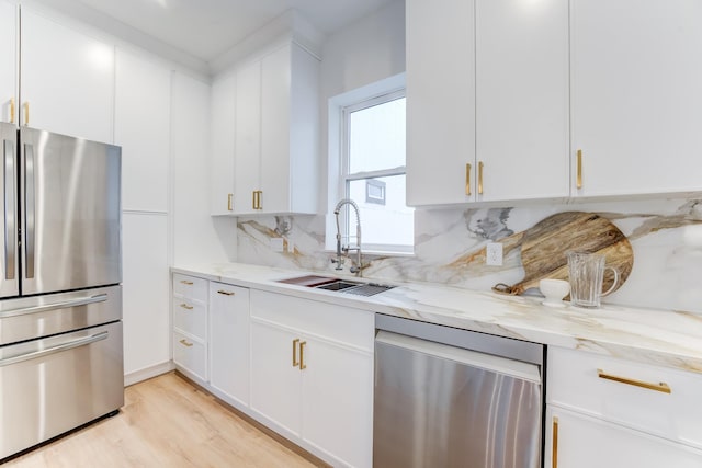 kitchen featuring appliances with stainless steel finishes, sink, and white cabinets