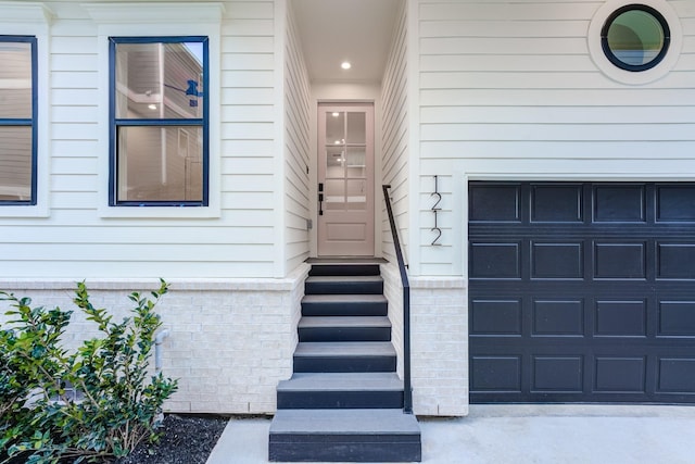 view of exterior entry with a garage