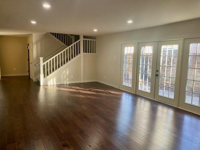 unfurnished living room with french doors and dark hardwood / wood-style flooring