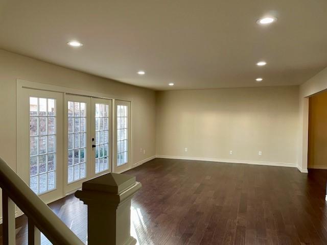 unfurnished room featuring dark wood-type flooring