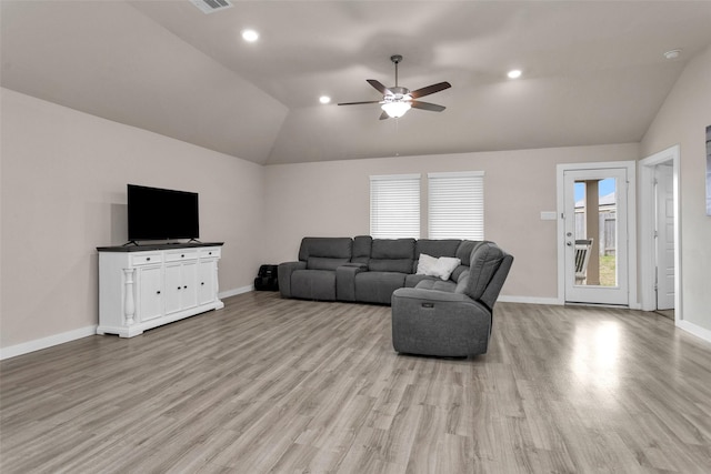 living room featuring ceiling fan, lofted ceiling, and light hardwood / wood-style floors