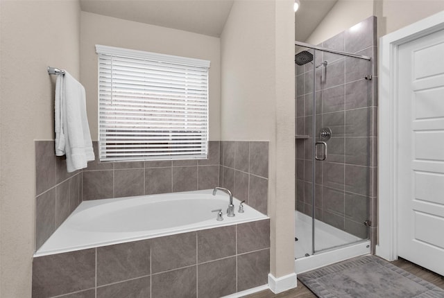 bathroom featuring hardwood / wood-style floors, vaulted ceiling, and shower with separate bathtub