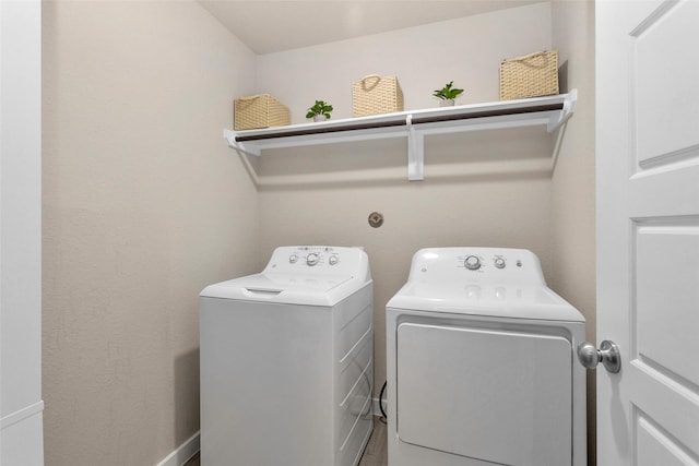 clothes washing area featuring washing machine and clothes dryer