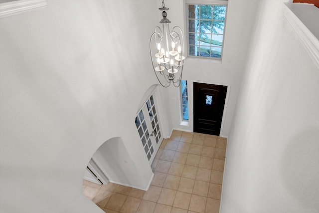 entrance foyer featuring light tile patterned floors and a notable chandelier