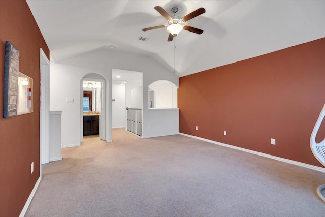 unfurnished living room with lofted ceiling, light colored carpet, and ceiling fan