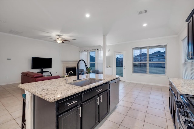 kitchen with a center island with sink, dishwasher, ornamental molding, gas range oven, and sink