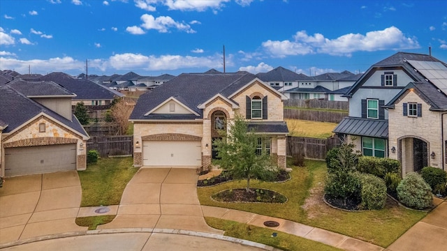 view of front of property with a front yard and a garage