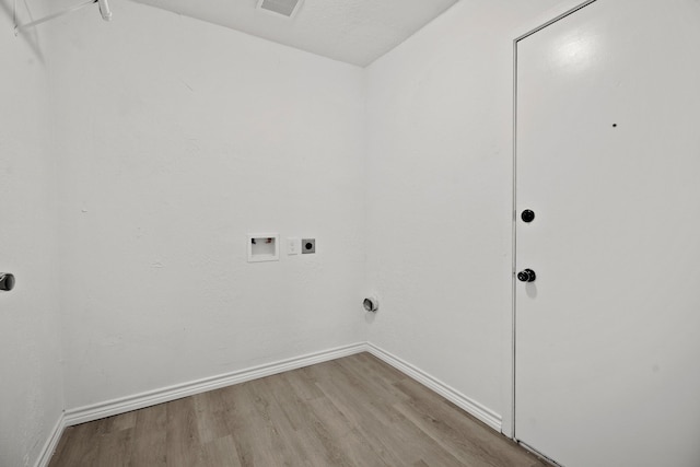 laundry area with washer hookup, electric dryer hookup, and light hardwood / wood-style floors