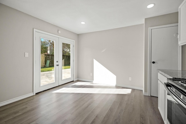 interior space with french doors and hardwood / wood-style floors