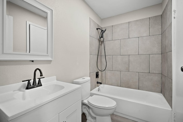 full bathroom with tiled shower / bath combo, vanity, and toilet