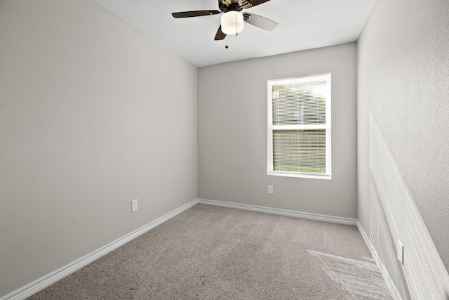 spare room featuring ceiling fan and carpet flooring