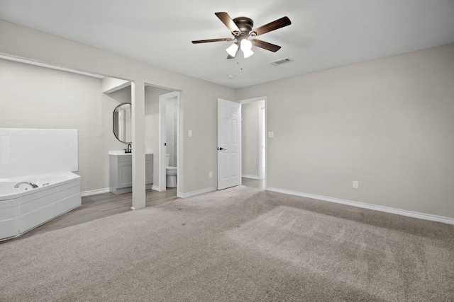 unfurnished bedroom with ceiling fan and light colored carpet