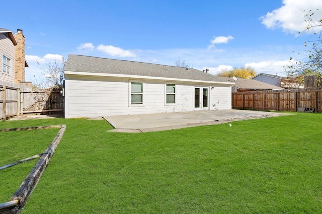 rear view of house with a lawn and a patio