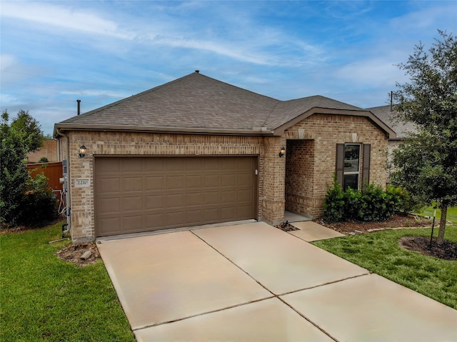 single story home featuring a garage and a front yard