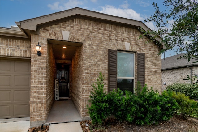 view of exterior entry featuring a garage