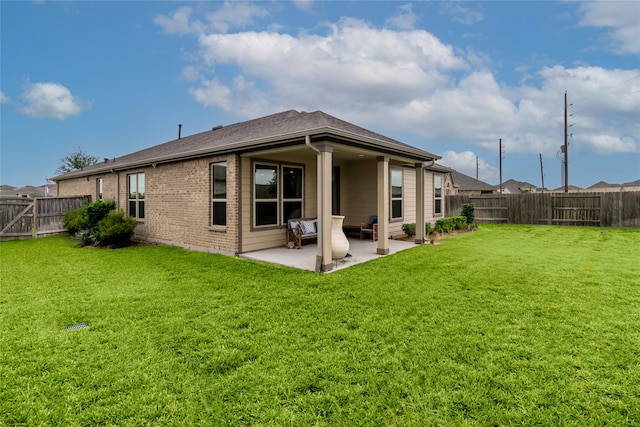 rear view of house with a yard and a patio