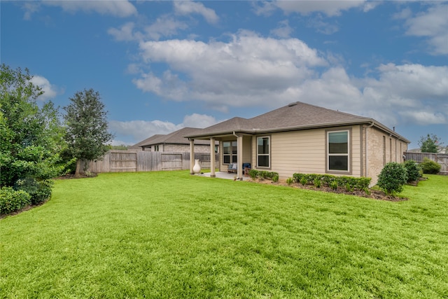 back of property featuring a lawn and a patio