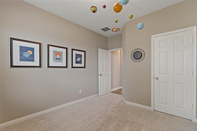 unfurnished bedroom with light carpet and ceiling fan