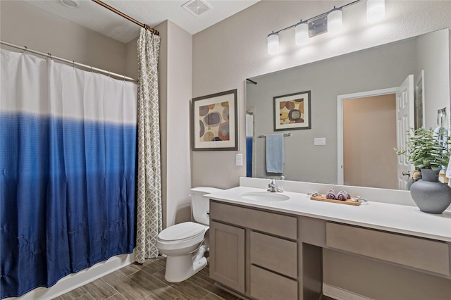 bathroom with toilet, vanity, and a shower with shower curtain