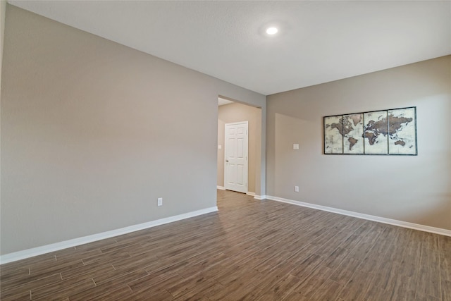 empty room with dark hardwood / wood-style flooring