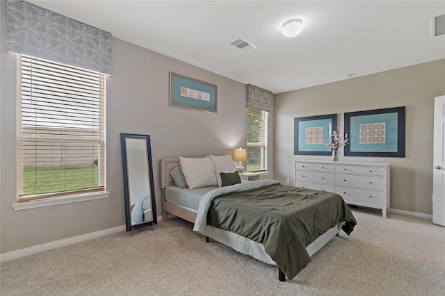 bedroom with light colored carpet