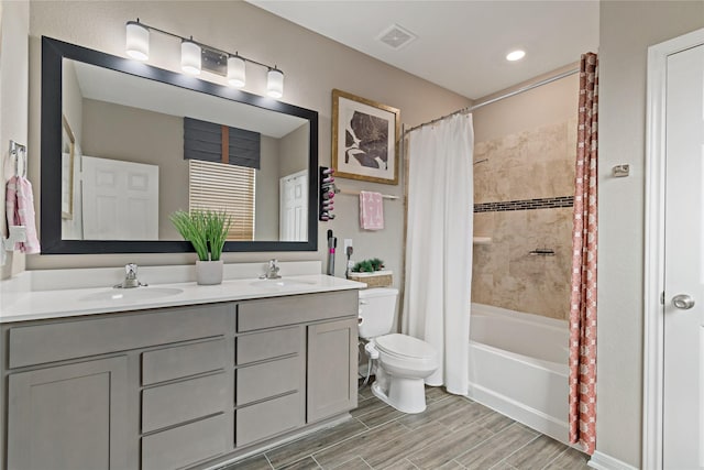 full bathroom with toilet, shower / tub combo, and vanity