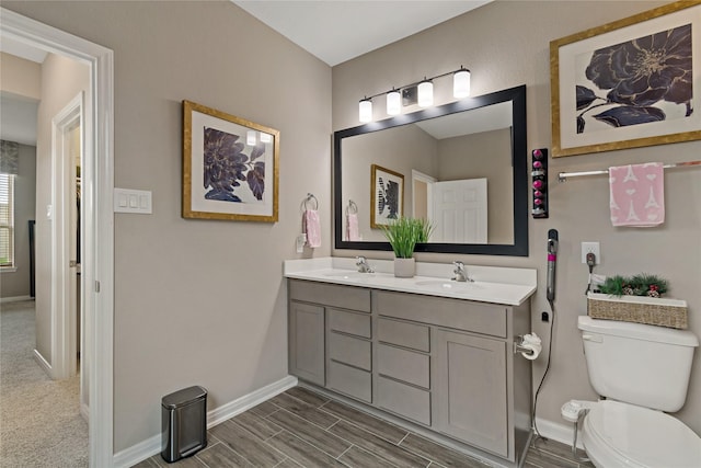 bathroom with toilet and vanity