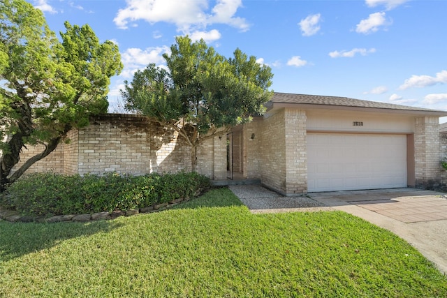 view of front of house with a garage and a front lawn