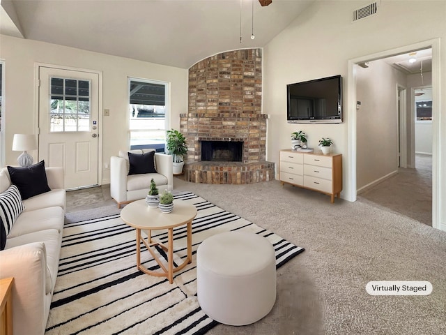 living room with lofted ceiling, light colored carpet, and a brick fireplace