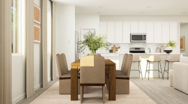 dining space featuring light hardwood / wood-style floors